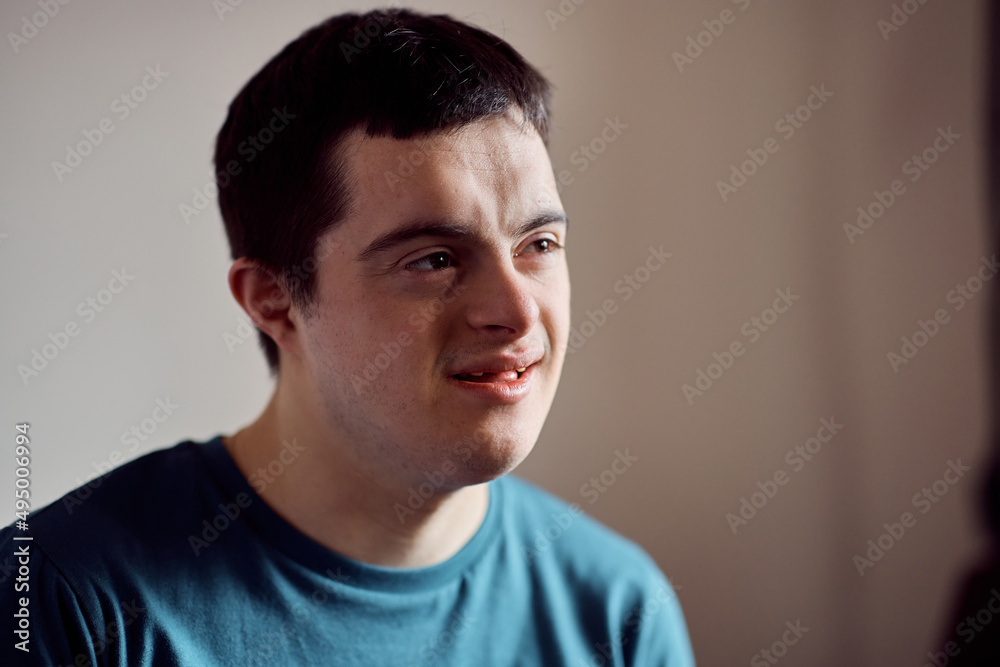 Portrait of smiling man with down syndrome at home. Portrait of smiling man with down syndrome at home.