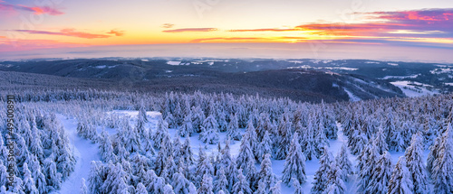 Winter landscape in the mountains at sunset, snow-capped mountain peaks and forest, the view from the observation tower.