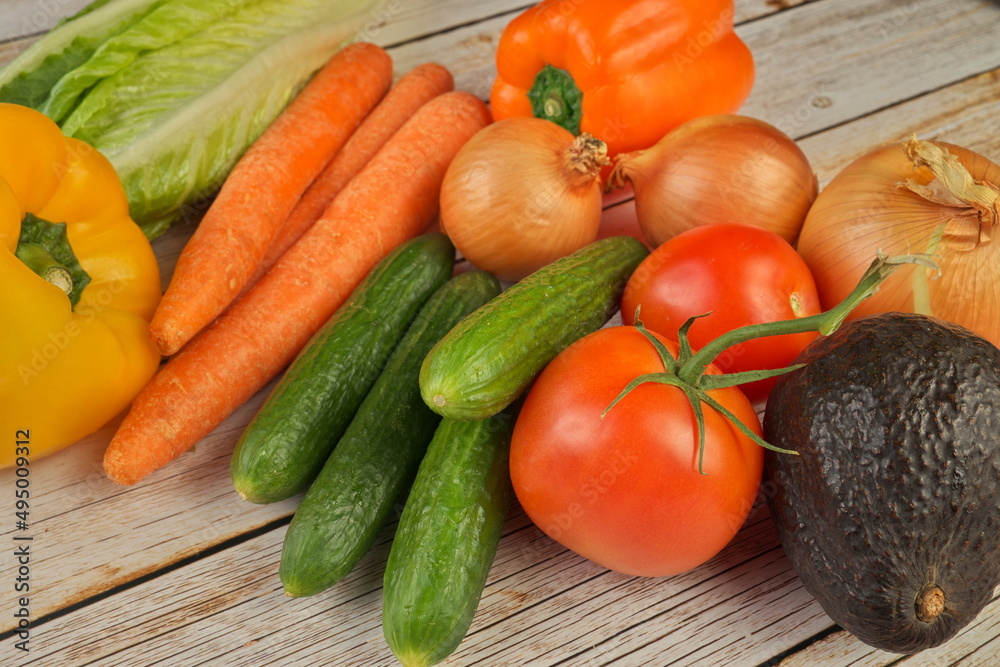 High Angle View of Selection of Fresh Summer Vegetables on a Rustic Wooden Table High Angle View of Selection of Fresh Summer Vegetables on a Rustic Wooden Table