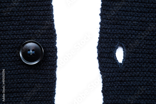 button and buttonhole of blue wool sweater photo