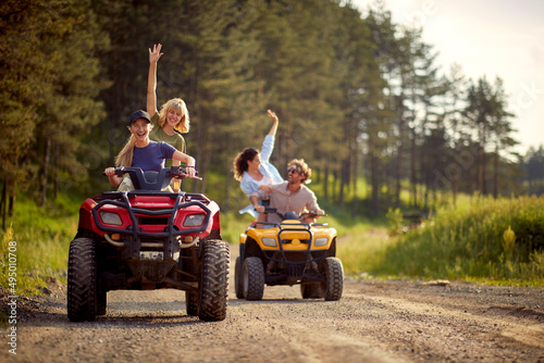 Young friends ride quads on a road in the nature. © luckybusiness