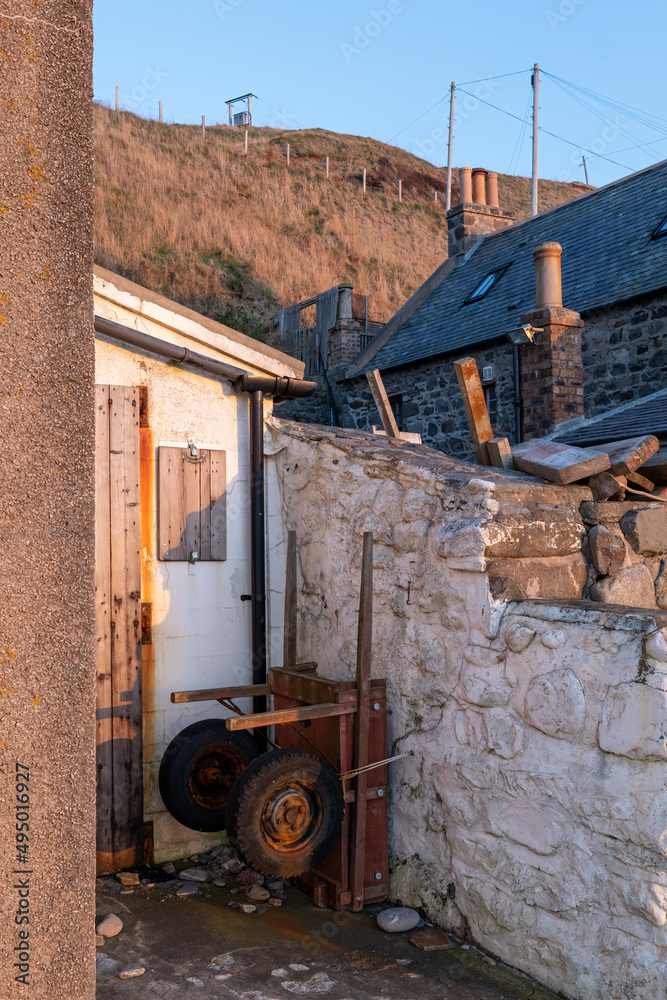 20 March 2022. Crovie, Aberdeenshire, Scotland. This is the row of houses that was the old coastal fishing village of Crove carching the Sun. The ver small village is now mostly holiday homes.