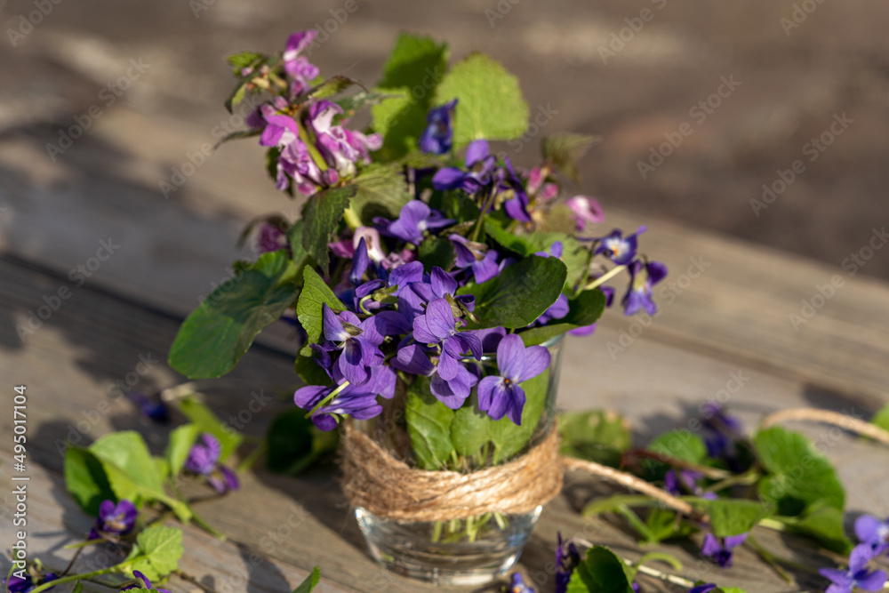 lilac viola flowers in a jute basket