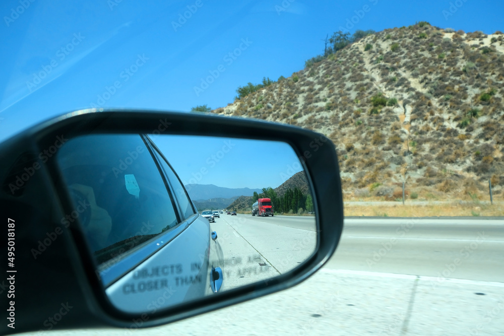 Image through the rearview mirror of a car with the inscription Image through the rearview mirror of a car with the inscription