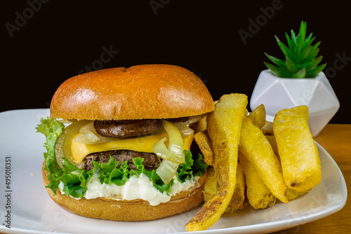 cheese burger top with  cheese and served with steak fries