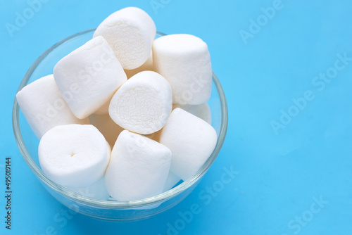 Delicious white marshmallows on blue background.