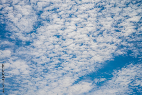 Smooth white clouds on clear blue sky background and copy space. Outdoor nature or save the earth concept.