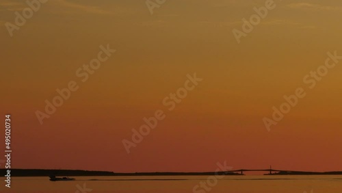 A view of the sunrise over Lake Saroma. A fishing boat that goes on the surface of the lake. (pan, copy space)  photo