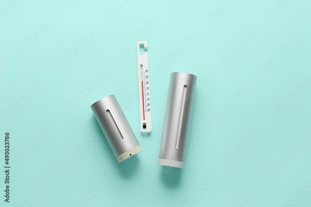 Home weather station and thermometer on color background Home weather station and thermometer on color background