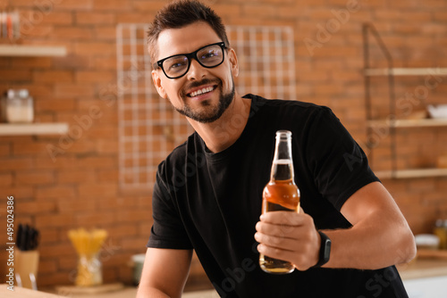 Handsome man drinking beer ...