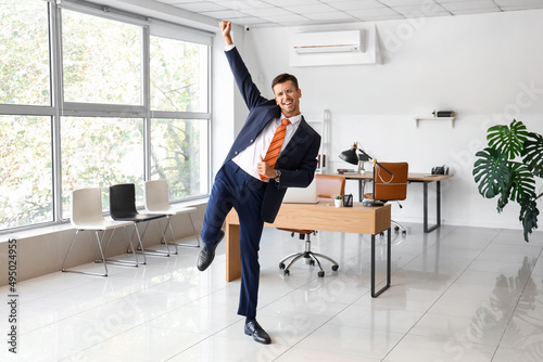 Dancing young businessman i...