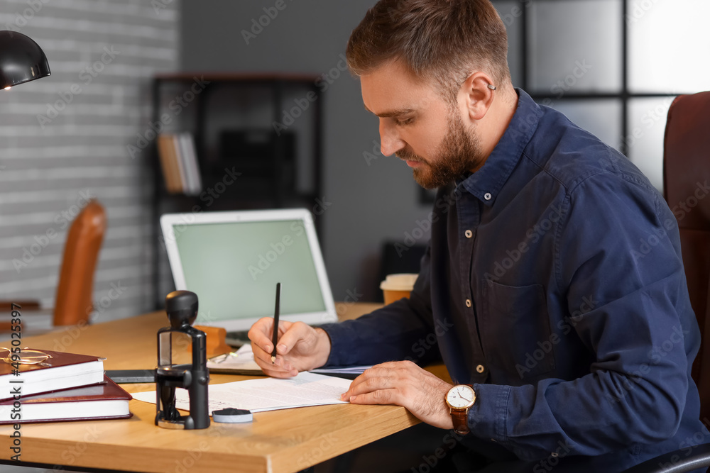 Male notary public working in office Male notary public working in office