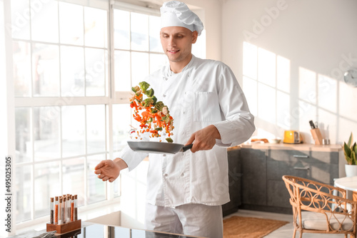 Male chef frying tasty vege...