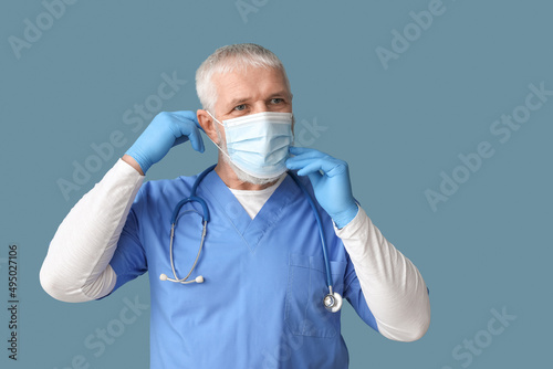 Mature male doctor wearing ...