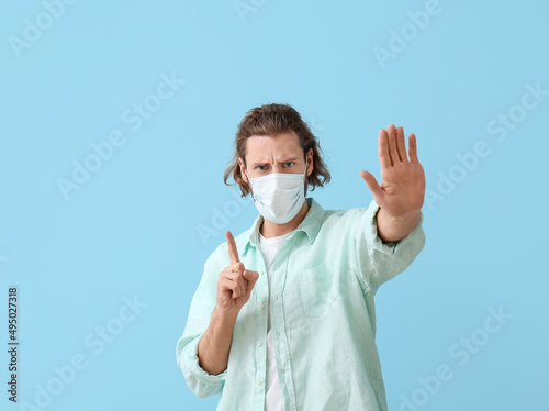 Young man in medical mask s...