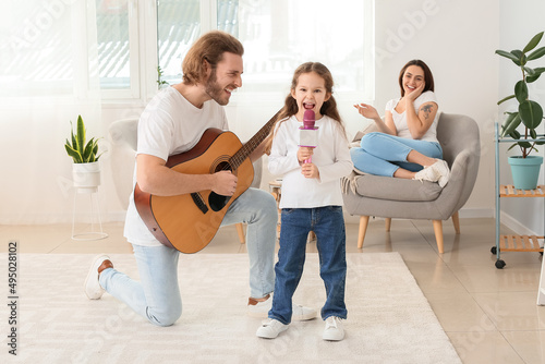 Little girl singing into mi...