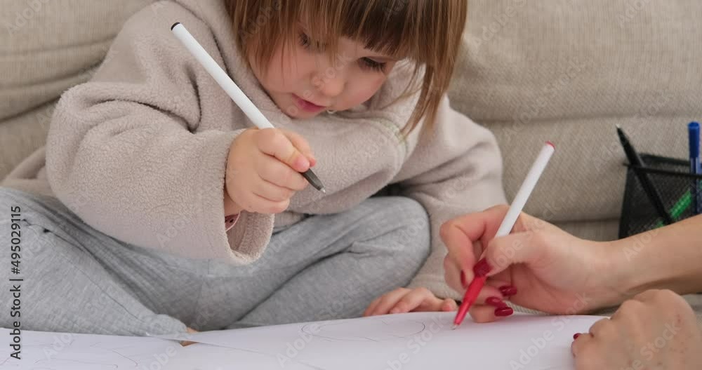 Mother with adorable daughter drawing on paper at home Mother with adorable daughter drawing on paper at home