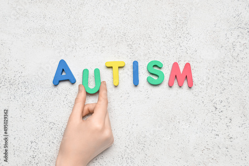 Woman with word AUTISM on l...