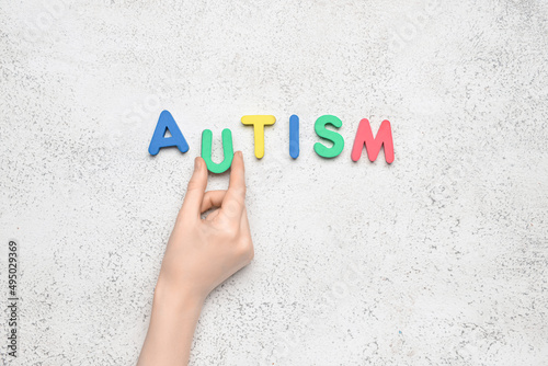 Woman with word AUTISM on l...