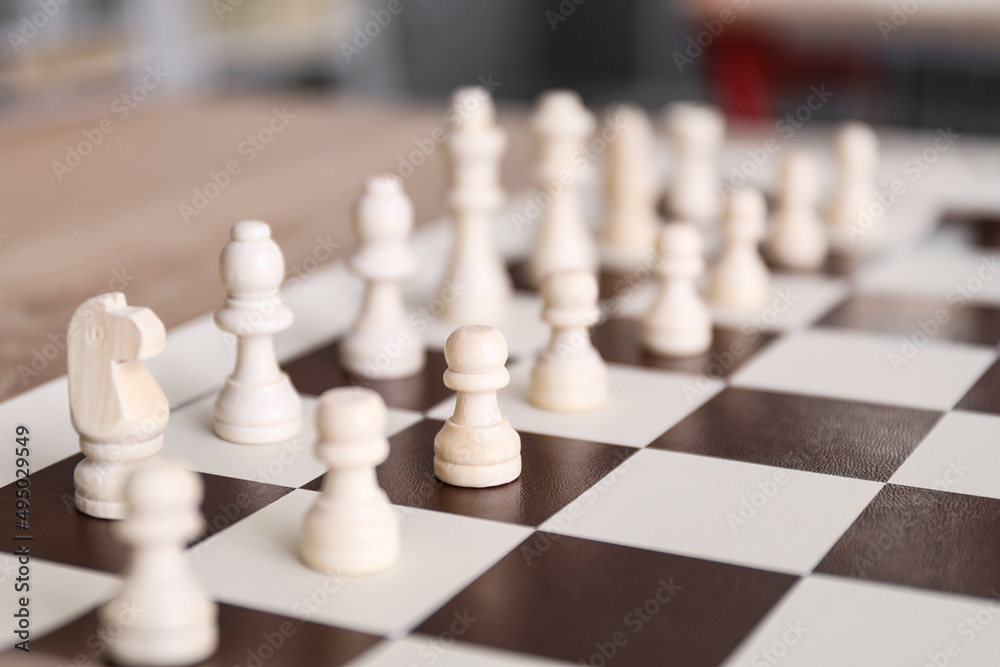 Board with chess pieces on table,  closeup