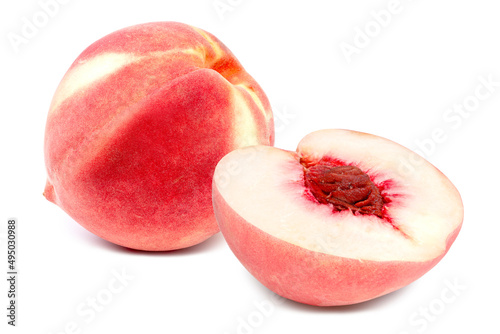 Fresh peaches both whole and a half with kernel on white background with clipping path	
