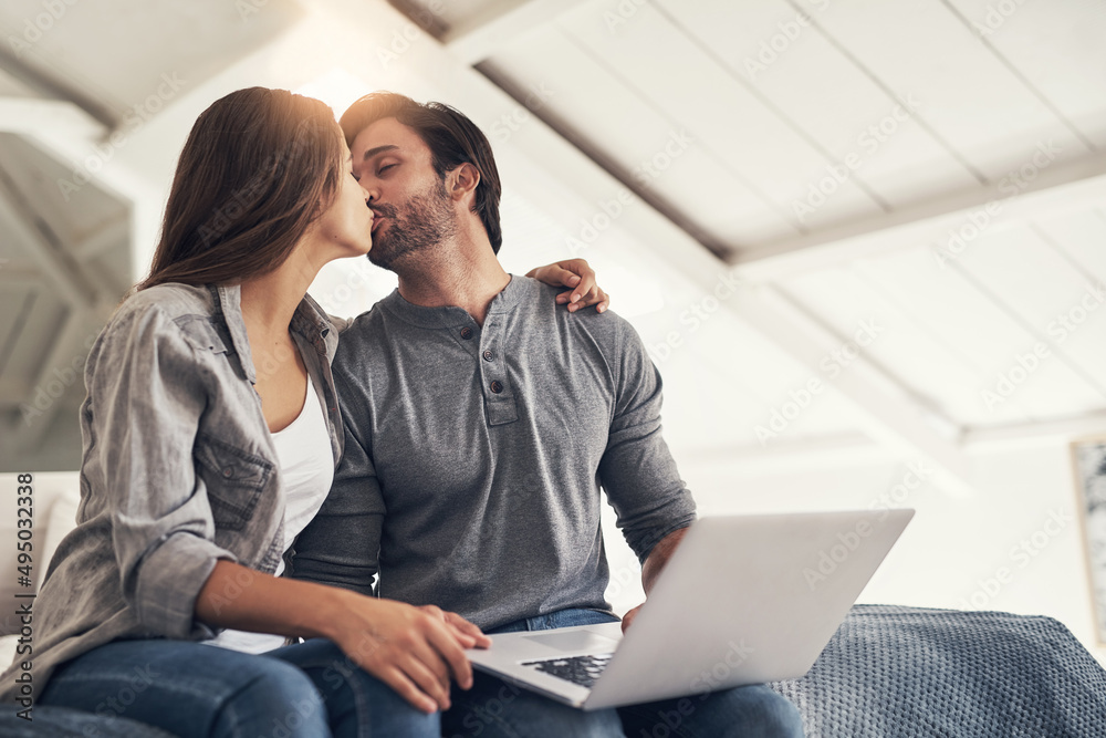 Snogging before we start blogging. Shot of an attractive young couple spending quality time at home. Snogging before we start blogging. Shot of an attractive young couple spending quality time at home.