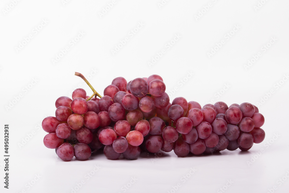 Fototapeta premium Red grapes photographed in a studio on a white background.