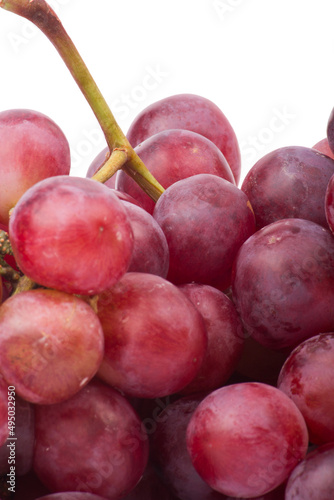 Red grapes photographed in a studio on a white background.