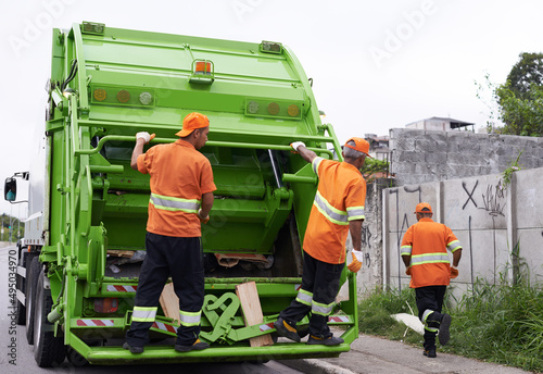 Keeping the city clean. Cropped shot of a team of garbage collectors. photo