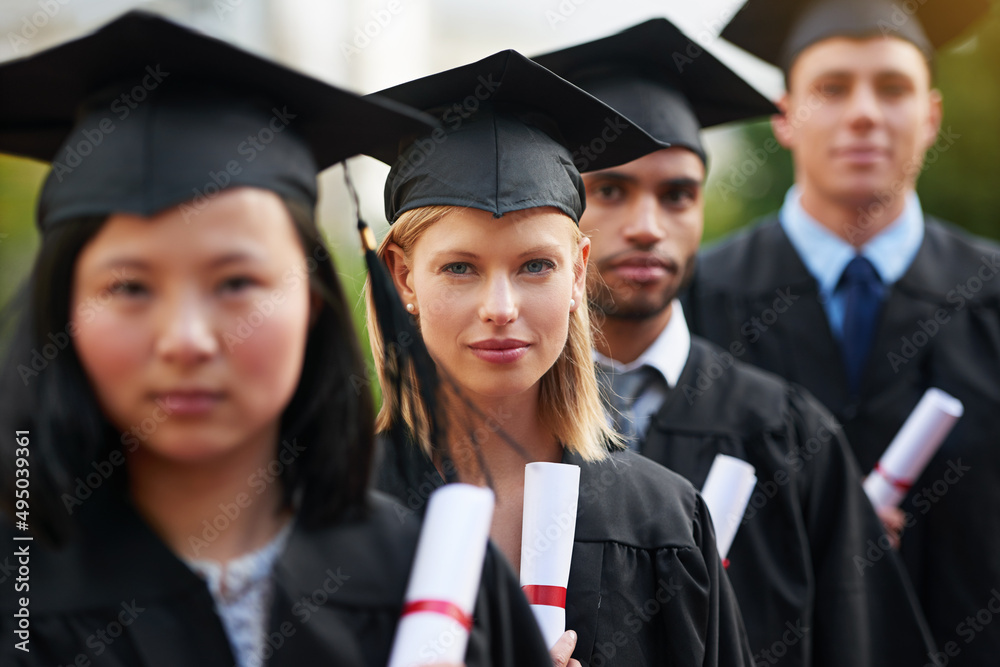 This is the beginning, of anything you want. A group of college graduates standing in cap and gown and holding their diplomas. This is the beginning, of anything you want. A group of college graduates standing in cap and gown and holding their diplomas.
