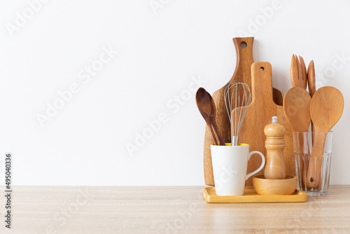 Kitchen utensils background with,cutboard, bowls on the table on white background. Blank space for a text, home kitchen decor concept.