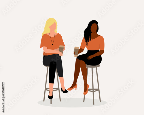 Two Young Woman With Different Ethnic Having Coffee Together.