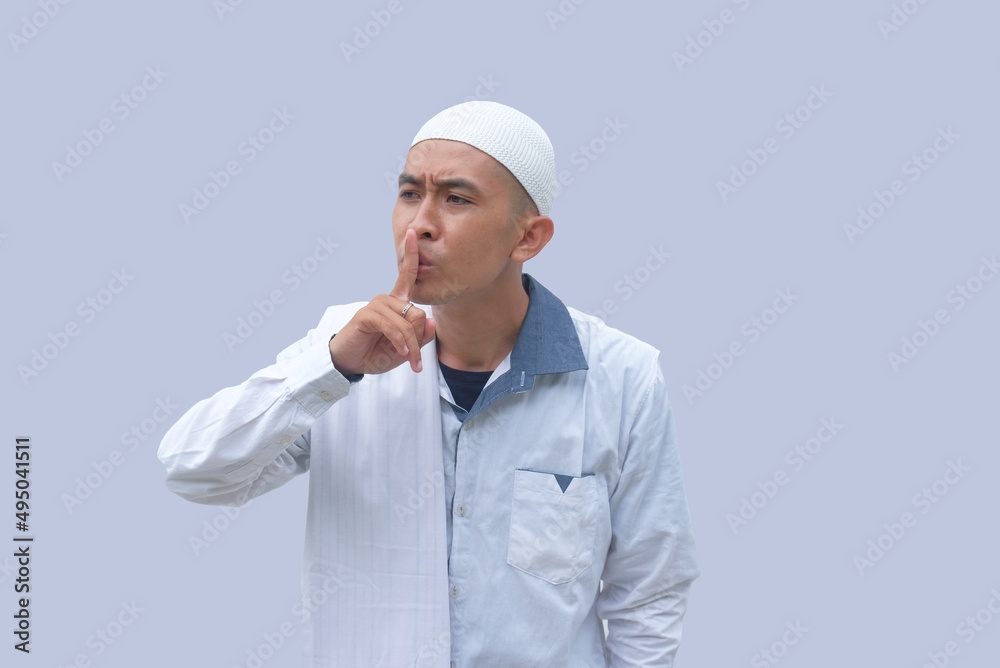 portrait of muslim man with silent gesture portrait of muslim man with silent gesture