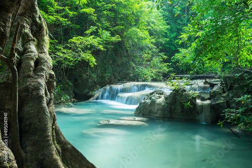 Beautiful Erawan tropical waterfall in Kanchanaburi province, Thailand. Travel tropical forest concept.