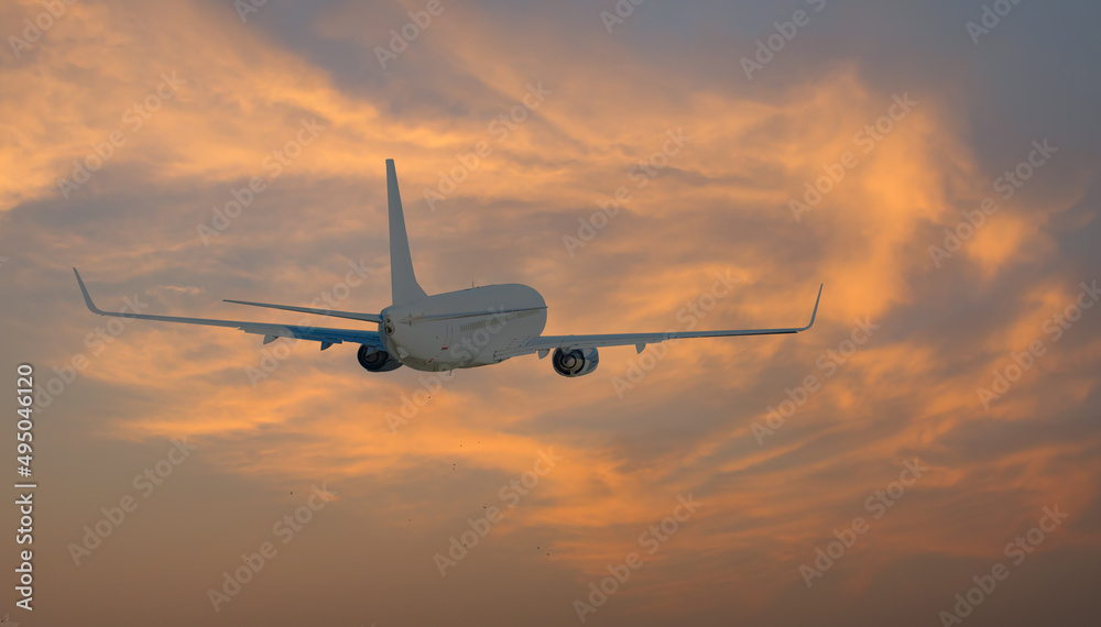 Obraz premium White passenger airplane flying in the sky amazing clouds in the background - Travel by air transport