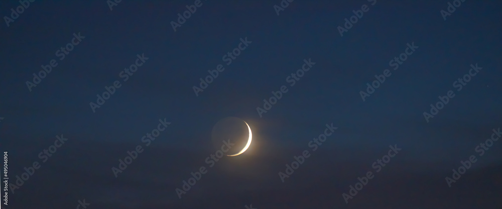 Young moon on night sky
