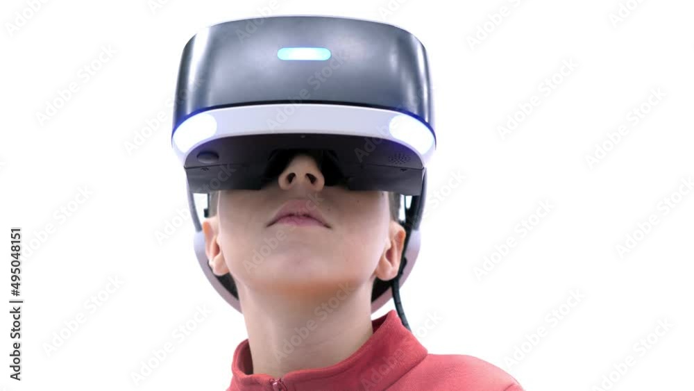 the boy in virtual reality glasses is playing.