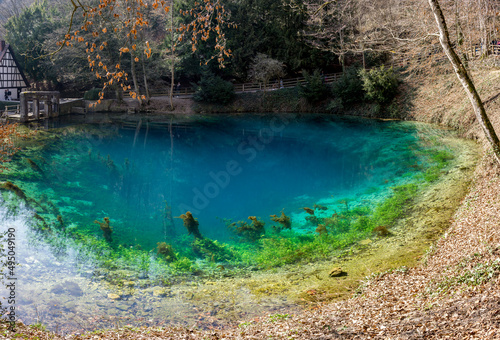 Beautiful and deep little lake with source on the bottom and nice green and blue colours called Blautopf in Germany