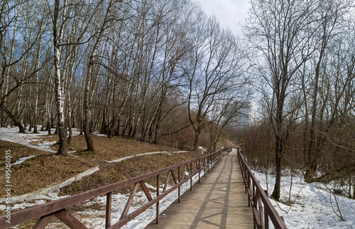 A footbridge at the bottom of a small ravine.