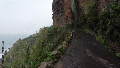 Drone view of seashore waterfall on Madeira. Green mountains. Portugal