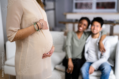 Photos Pregnant Woman Touching Her Belly's Woman Standing In Front