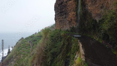 Drone view of seashore waterfall on Madeira. Green mountains. Portugal