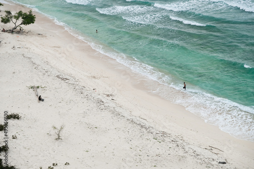 Beautiful view of Cristo Rei Backside Beach or known as Dolok Oan Beach in Dili, Timor Leste. Sea waves background. Aerial view of tropical beach. photo