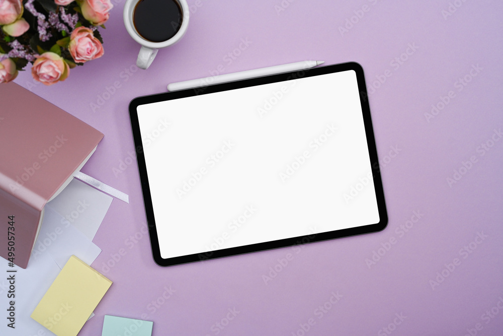 Digital tablet with white screen, notebook, coffee cup and sticky notes on purple background. Digital tablet with white screen, notebook, coffee cup and sticky notes on purple background.