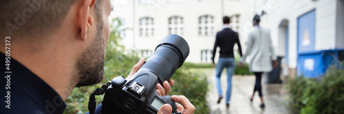 Man Taking Photograph Of Couple Walking Together At Outdoors