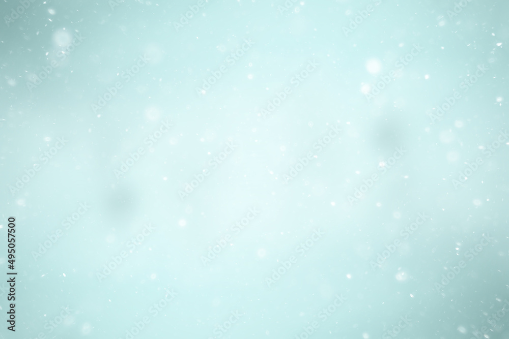blurred snow / winter abstract background, snowflakes on abstract blurred glowing leaf background