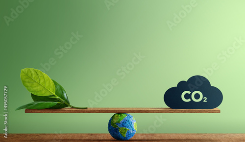 Carbon Neutral and ESG Concepts. Carbon Emission, Clean Energy. Globe Balancing between a Green leaf and CO2. Sustainable Resources, Big deal for Company and Indstry to Concern about Environmental photo