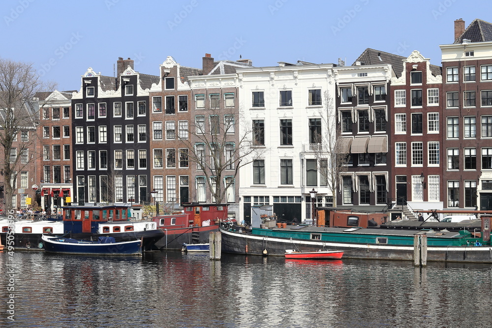 Amsterdam Amstel River View with Historic Architecture and Colorful Houseboats, Netherlands