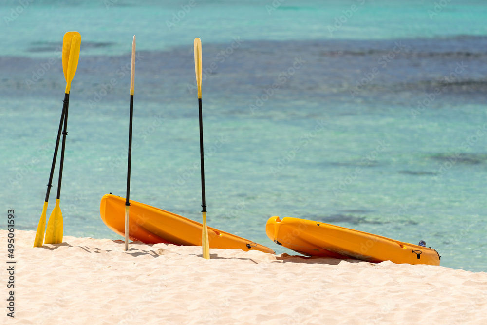 Orange boats with oars on the sandy shore. Beautiful seascape on the Caribbean Sea in the Dominican Republic Orange boats with oars on the sandy shore. Beautiful seascape on the Caribbean Sea in the Dominican Republic