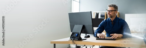 Businessman Using Business Computer In Office photo